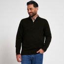 Man modelling a dark olive quarter-zip knitted jumper with a checked shirt and blue jeans, shown from a three-quarter angle.