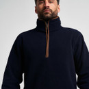 Close-up of men’s navy quarter-zip fleece showing the high collar and contrast brown zip detailing.