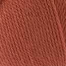 Close-up of tightly twisted burnt orange yarn strands arranged diagonally, showing the texture and weave of the wool.