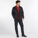 A man standing wearing a navy jacket over a red t-shirt