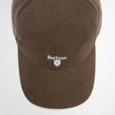 Brown baseball cap with "Barbour" text and a small blue shield logo on the front. The minimal design conveys a classic and casual style.