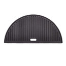 Black cast iron grill pan with ribbed surface, shaped like a half-moon, designed for cooking and grilling.