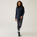 Full-length view of the model wearing the navy Regatta half-zip fleece with leggings and walking shoes.