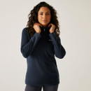 Model wearing a navy Regatta half-zip fleece with high collar and embroidered chest logo.