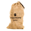 A burlap sack of apple wood chunks from Kamado Joe, isolated on a white background.