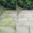 Side-by-side comparison of flagstone paving. The left side is green with moss, the right is clean, showing a clear difference in maintenance.