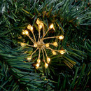 Close up of Premier 200 Micro Brights Starburst Battery LED String Lights, Warm White - 2.2m on  Christmas tree