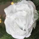 A close up view of a white velvet rose clip on decoration on a Christmas tree