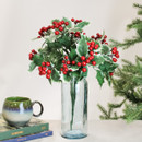 Artificial holly berry bush displayed in a glass vase, featuring variegated holly leaves and glossy red berries to create a classic Christmas centrepiece for festive home décor.