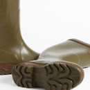 Close-up of two olive green rubber wellington boots with brown soles on a white background. The focus is on the textured tread, emphasizing durability.
