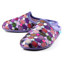 Pair of women's slippers with a vibrant multicoloured knitted-style upper featuring textured dot patterns in pink, red, green, white, and purple. The slippers have a soft purple inner lining and collar, paired with a purple sole. The slip-on mule design offers comfort and easy wear, with a light blue brand label on the side.