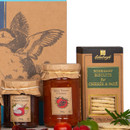 Close-up of Coast Hamper products showing Caramelised Onion Chutney, Spicy Tomato Chutney, and Rosemary Biscuits for Cheese & Pâté, styled with cherry tomatoes and herbs.