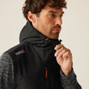 Close-up: Men’s black hooded jacket with Regatta Professional logo, zip front, adjustable hood, outdoor workwear.