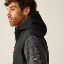 Men’s hooded jacket side view, black panel with grey fleece sleeves, performance outdoor apparel.