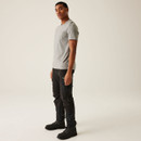 Side profile of black cargo work pants with articulated knees, tool pocket straps, zip compartments, and ergonomic fit for active jobsite performance.