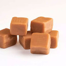 Close-up of creamy handmade Scottish fudge squares with smooth caramel texture on a white background.
