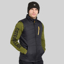 Man wearing a black CAT padded gilet over a green long-sleeve top and black beanie, shown from the front.