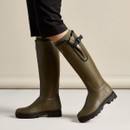 Le Chameau men’s green Wellington boots being worn, showing the tall profile, adjustable calf gusset and black tread sole.