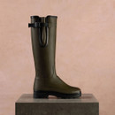 Side profile of a Le Chameau men’s green Wellington boot with adjustable calf gusset and chunky black tread sole.