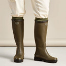 Le Chameau women’s green Giverny wellington boots worn with trousers and socks, showing the tall country boot design.