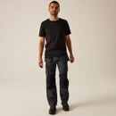 Full body: Male model wearing black work trousers with holster tool pockets and black t-shirt, professional tradesman outfit with durable cargo pants and safety work boots.