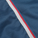 Close-up of teal turnout rug fabric showing red, white and grey binding trim detail