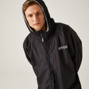 A man wearing a black waterproof changing robe.