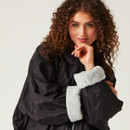 A close up view of the robe's sleeves turned up, showing the cosy fleece lining.