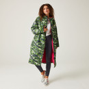 A full length view of a man wearing a green camo print waterproof robe.