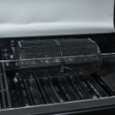 Mesh rotisserie basket on a barbecue spit, resting on the grill grates inside an open BBQ.