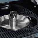 Close-up of stainless steel beer can chicken roaster sitting on a barbecue grill