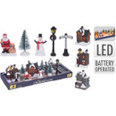 A village scene set including houses, snowmen, Santa, a tree, lamppost and street sign.