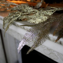 Close up of the glittery leaves of a Champagne Feathered Christmas Garland.