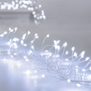 A close-up of delicate white fairy lights glowing softly along a silver wire, creating a magical, twinkling ambiance.
