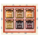 A Mrs Bridges Breakfast Collection gift set featuring six mini jars in a cream and orange-framed box. Flavours include Orange Marmalade Fine Cut, Orange Marmalade with Ginger, Fine Cut Dundee Marmalade, Celebration Marmalade with Champagne, Scottish Raspberry Preserve, and Scottish Strawberry Preserve.