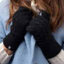 A person wearing a pair of black gloves. A person wearing a pair of black gloves.