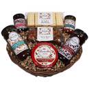 Wicker basket filled with gourmet treats, including shortbread, fruit cake, chutney, preserves, and Christmas pudding. A festive and indulgent selection.