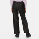 A person wearing black waterproof trousers and hiking boots, shown from the back, standing against a plain white background. The tone is practical and casual.