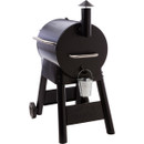 Black barrel-style BBQ smoker on wheels with side vent and front-mounted bucket.