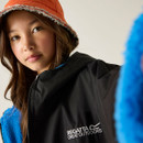 A Young person wearing a black Regatta Great Outdoors jacket and an orange bucket hat with frayed edges. They have a calm expression.