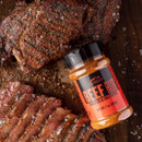 Traeger Beef Rub seasoning jar next to sliced smoked beef brisket