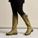 Le Chameau women’s olive green tall wellington boots being worn, showing the adjustable calf fit and treaded soles.