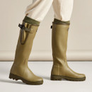 Le Chameau women’s olive green wellington boots being worn, showing the tall fit and adjustable calf gusset.