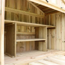Close-up of the wooden shelving and storage inside a garden bar unit.