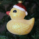 A close up view of a yellow rubber duck hanging decoration hanging on a Christmas trees