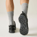 Rear view of black hiking shoes showing textured tread soles and reflective heel detail for visibility.