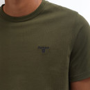 Close-up of a person's torso wearing an olive green Barbour T-shirt with a logo on the chest. The fabric appears soft and comfortable.