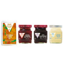 A Cottage Delight scone kit includes scone mix, strawberry jam, blackcurrant jam, and clotted cream, displayed in jars with vibrant labels.