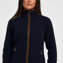 Close-up front view of a women’s navy fleece jacket showing the high collar, brown zip trim and zipped side pockets.