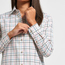 Detail view of women’s white check shirt showing the buttoned cuff, collar and multicoloured check design.